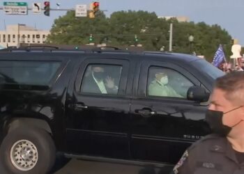 Donald Trump drives by supporters outside Walter Reed