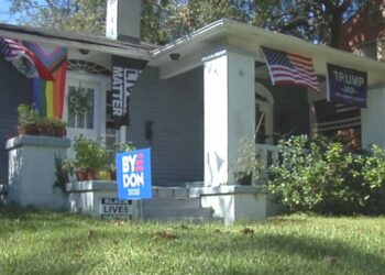 Neighbors share a roof but not political beliefs; plaster porch with opposing campaign signs